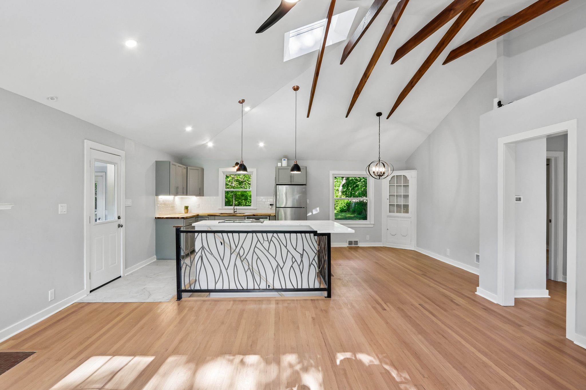 Interior photo of an updated, open concept home with exposed beams