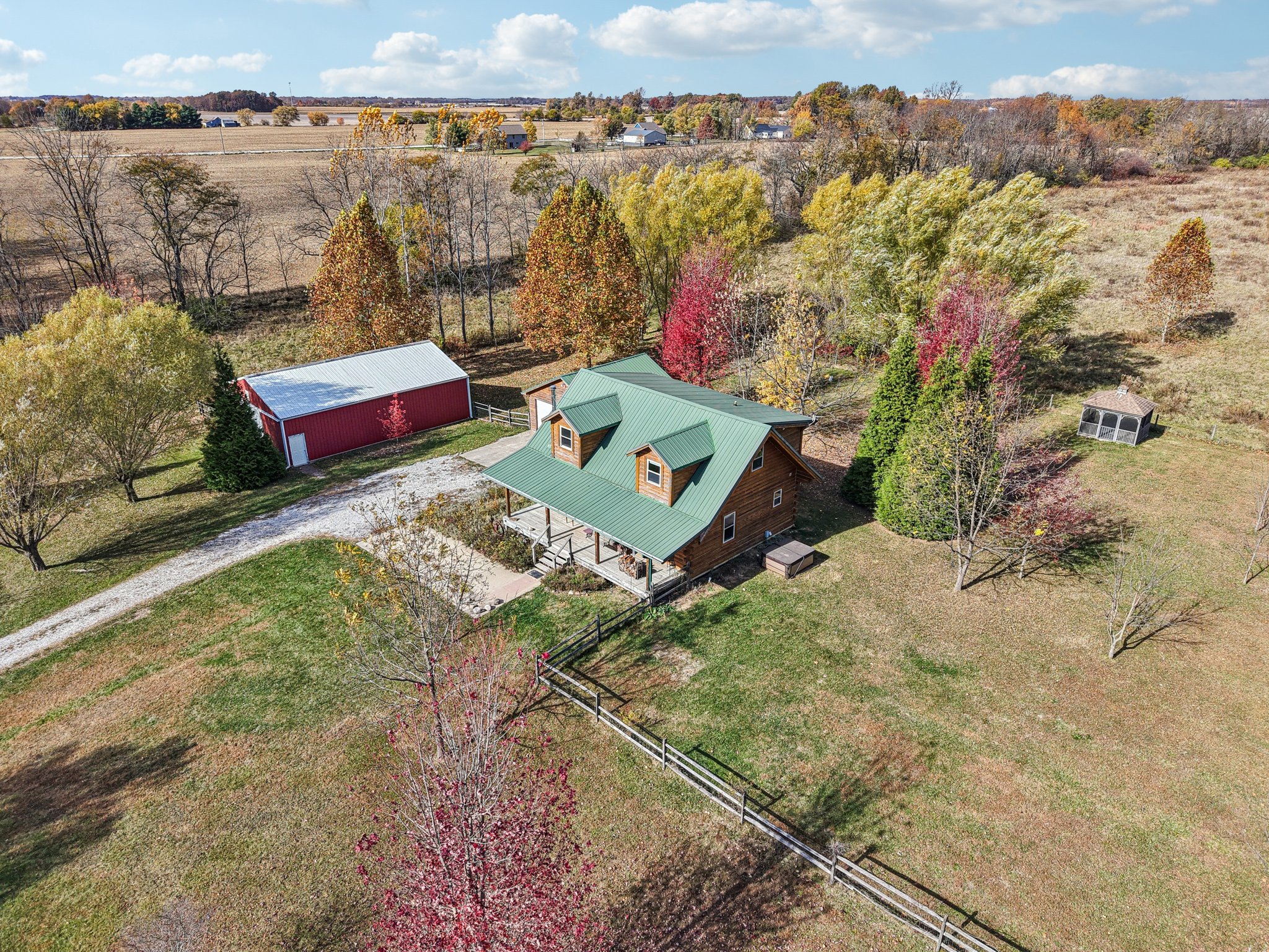 Photo of a log cabin and pole barn on acreage