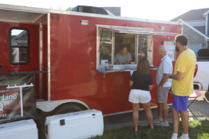 Top of the Line BBQ trailer and line for food